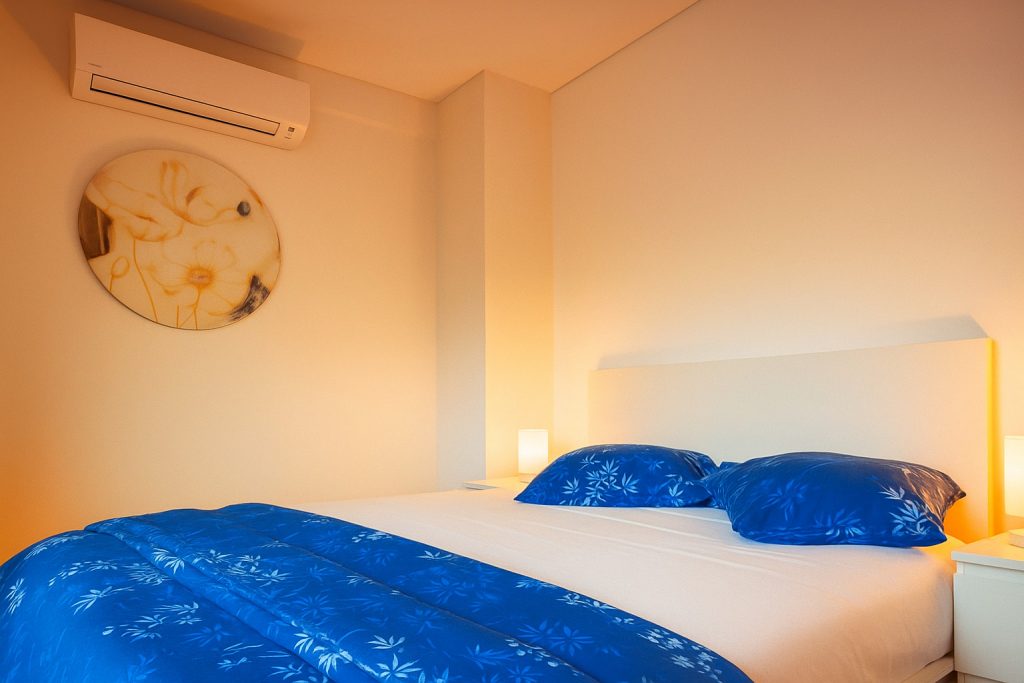 Bedroom with blue bedding at a vacation rental in Figueira da Foz