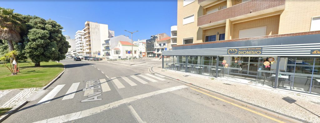 Exterior of Padaria Pastelaria Dionísio in Buarcos with large windows, striped signage, and a crosswalk in front